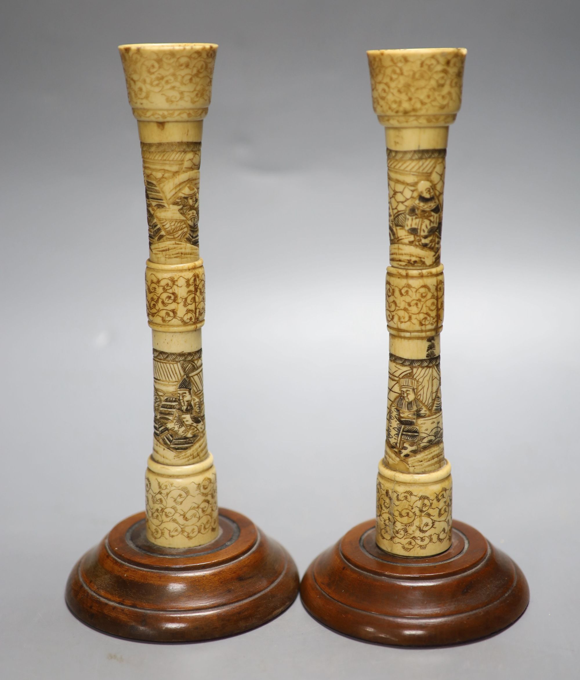 A pair of carved bone candlesticks, Meiji period, height 25cm